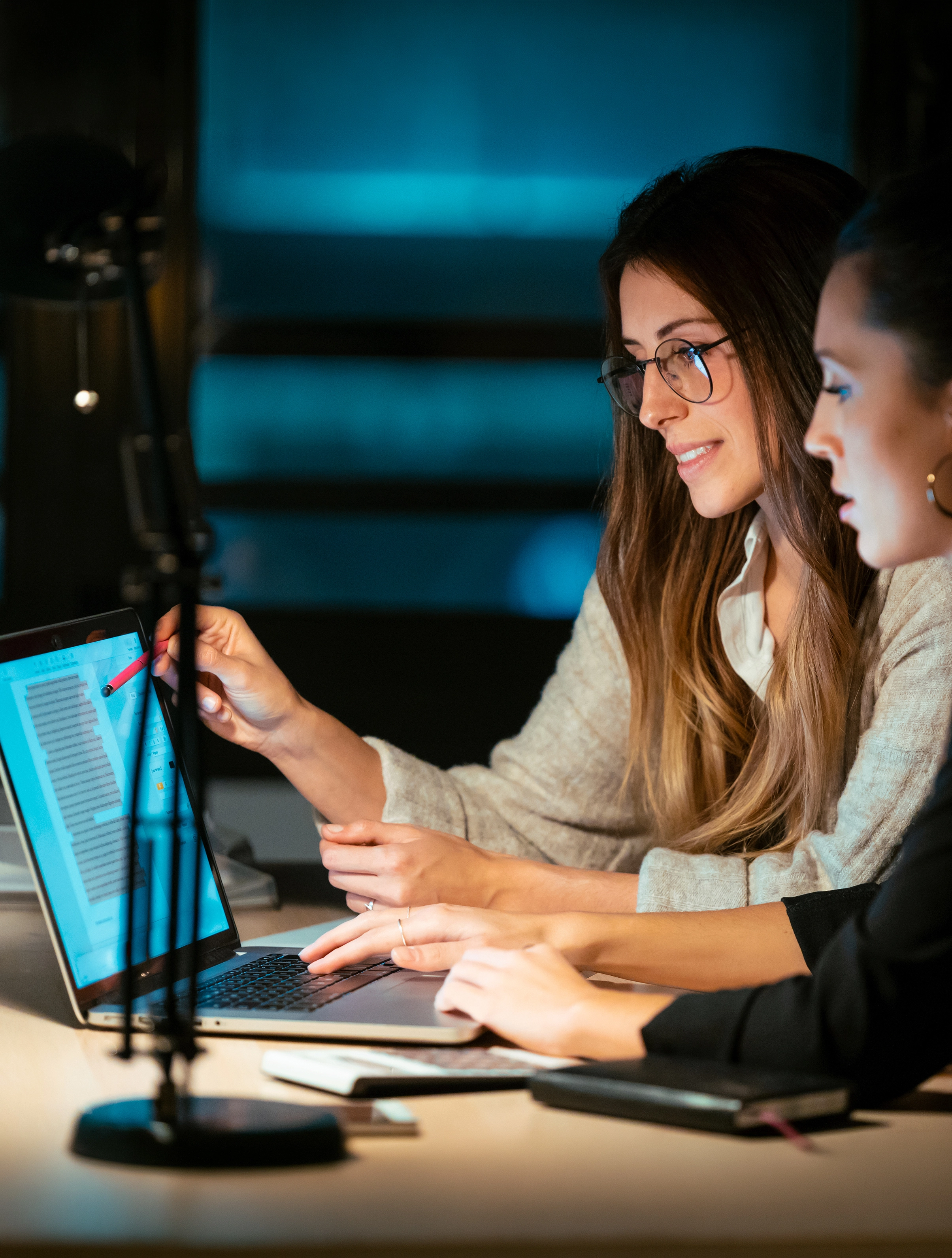 two-women-collaborating-on-a-laptop-at-night-2026-03-09-06-33-52-utc